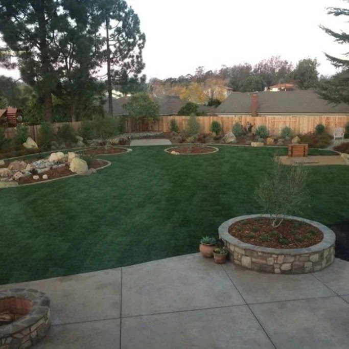 Backyard with new sod lawn, stamped-concrete patio and fire pit
